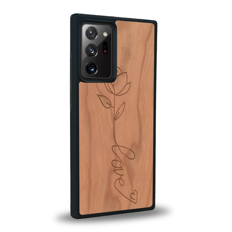 Coque de protection en bois véritable fabriquée en France pour Samsung Note 20+ sur le thème de la fête des mères avec un motif représentant une fleur dont la tige forme le mot "love"