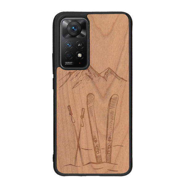 Coque de protection en bois véritable fabriquée en France pour Xiaomi Redmi Note 11 Pro sur le thème de la montagne, du ski et de la neige avec un motif représentant une paire de ski plantée dans la neige avec en fond des montagnes enneigées