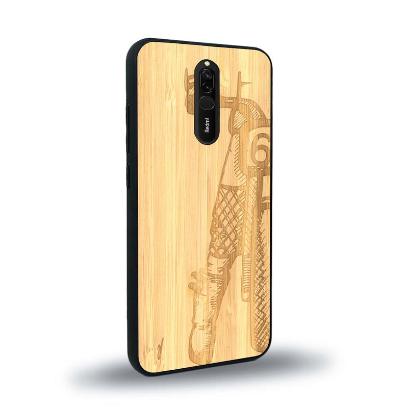 Coque de protection en bois véritable fabriquée en France pour Xiaomi Redmi 8 représentant une vue de face d'une femme sur une moto vintage dessinée à la main par l'artiste Maud Dabs